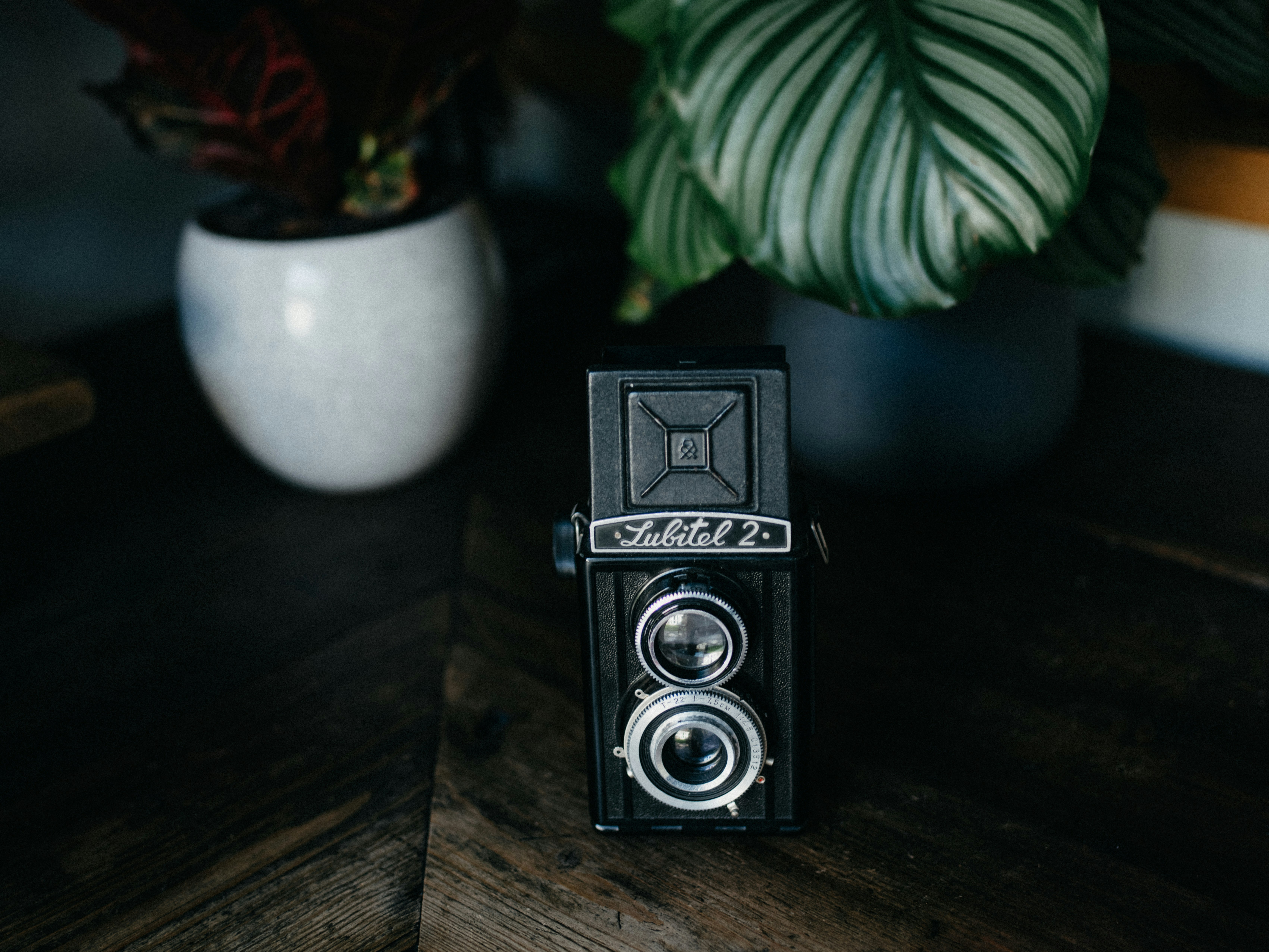 black and silver camera on brown wooden table